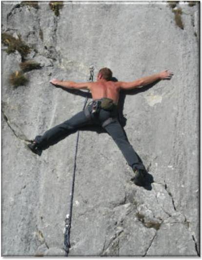 FastTrax Personal Development & Leadership graphic Brave man taking a risk by scaling a vertical cliff face